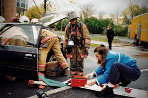 Kelly Hirsch, then president of the Syracuse University Ambulance and an EMT-D, works with the Syracuse Fire Department at a simulated DWI accident on campus in 1996. Photo by Bradley Wilson 694C15A